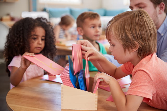 a group of children sitting at a table