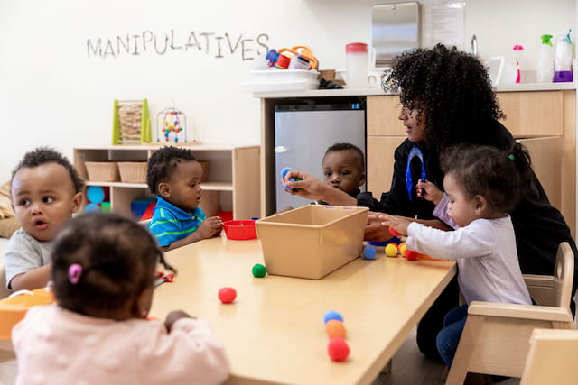 a group of children sitting around a table