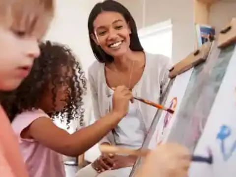 a woman drawing on a white board