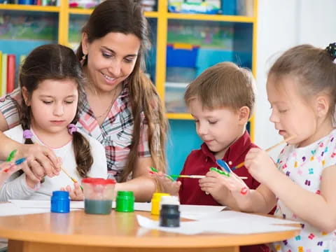 a person and children painting