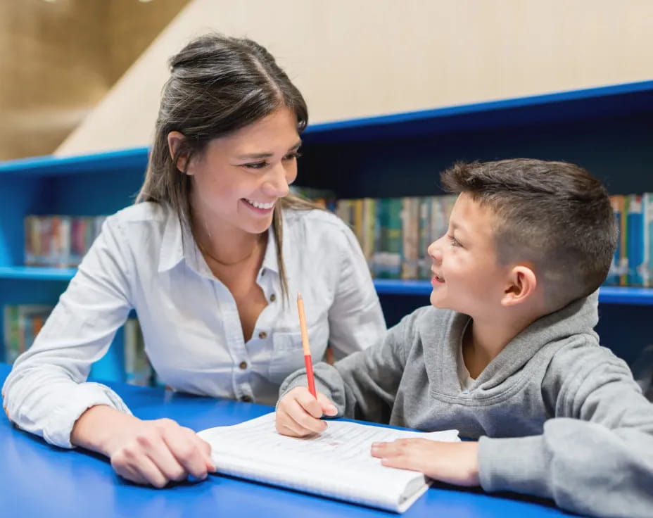 a woman and a boy studying