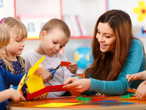 a teacher helping her students