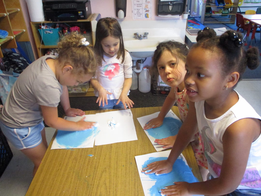 a group of children sitting at a table