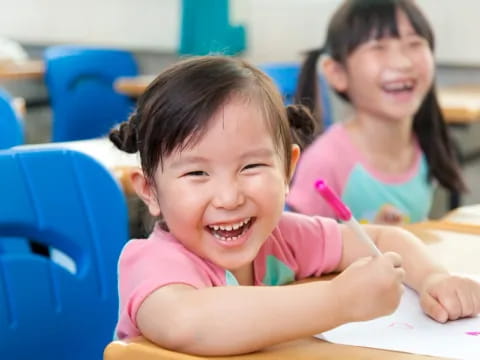 a couple of young girls smiling