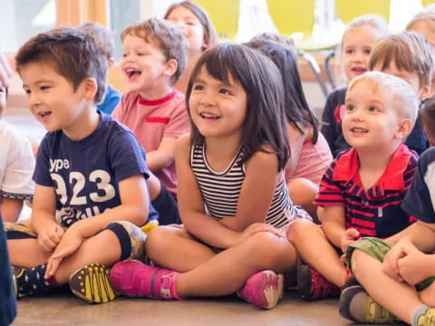 a group of children sitting on the ground