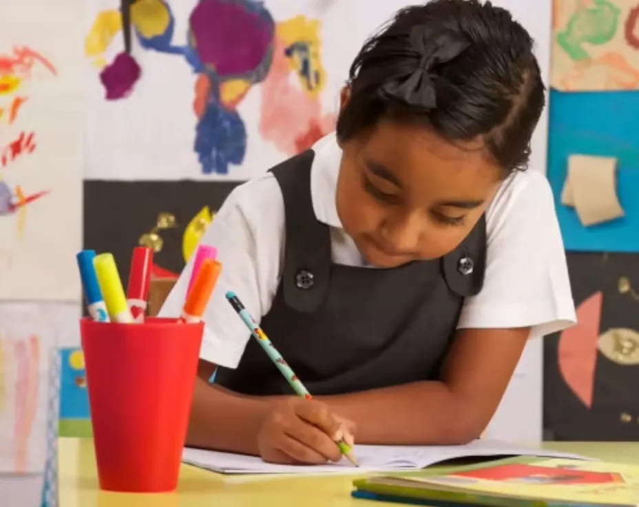 a person writing on a piece of paper