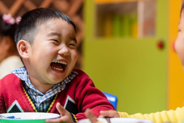 a young boy laughing