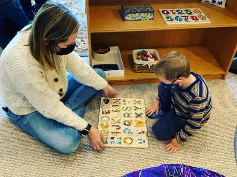 a person and a boy playing with a box