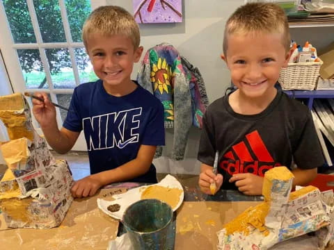 two boys sitting at a table