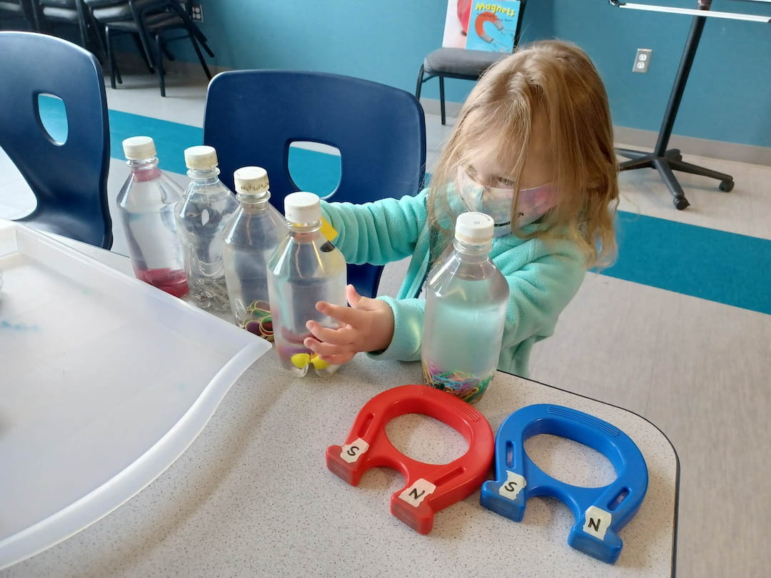 a girl playing with toys