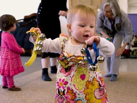a baby holding a toy