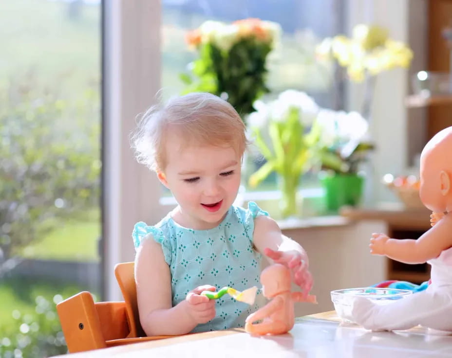 a baby sitting at a table