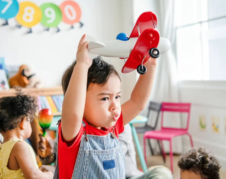 a person holding a red toy