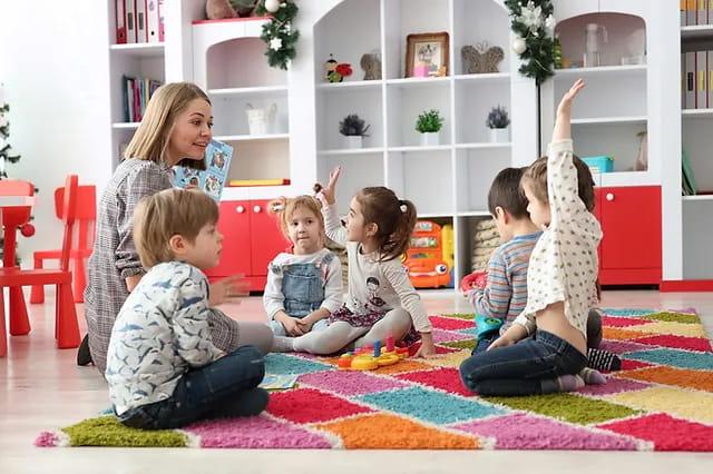 a person and several children sitting on the floor