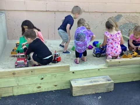 a group of children playing with toys