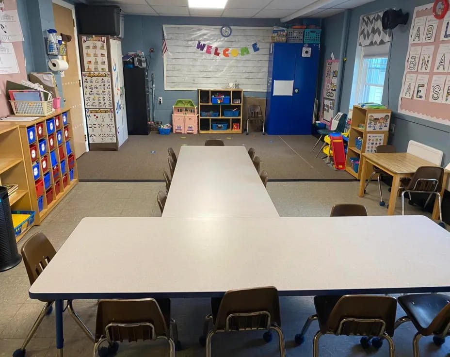 a classroom with tables and chairs