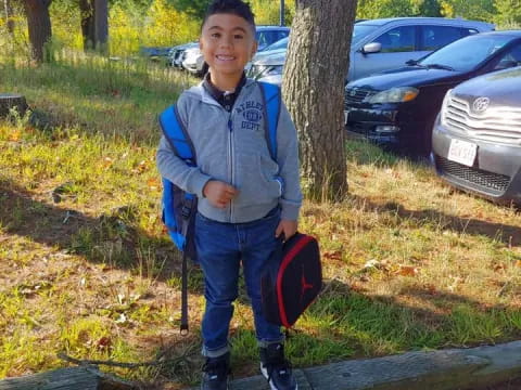 a boy standing on a log