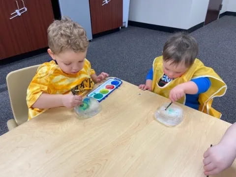 two boys sitting at a table