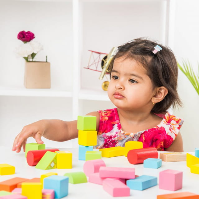 a girl playing with blocks