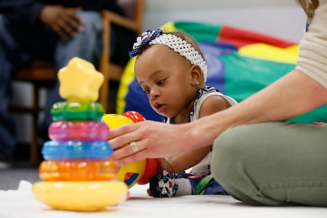 a baby playing with toys