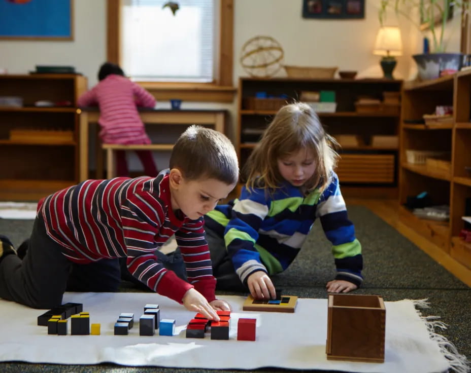 a boy and girl playing with toys