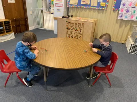 two boys sitting at a table