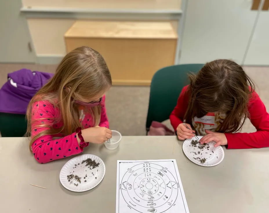 a couple of girls eating at a table