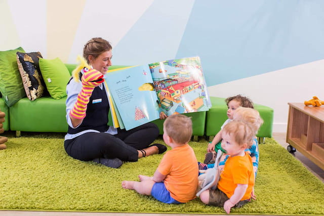 a person and several children sitting on the floor