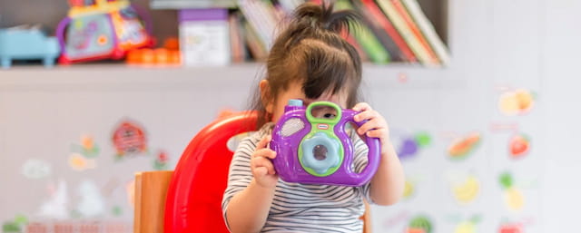 a girl holding a toy