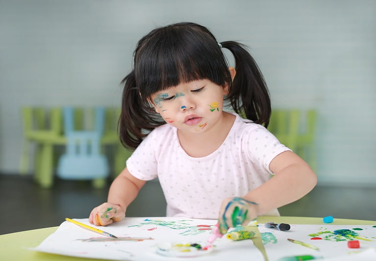 a young girl painting