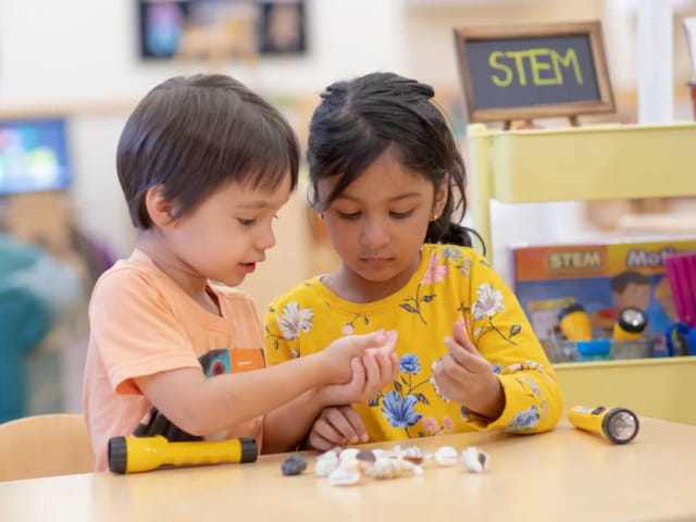 a couple of children playing with toys