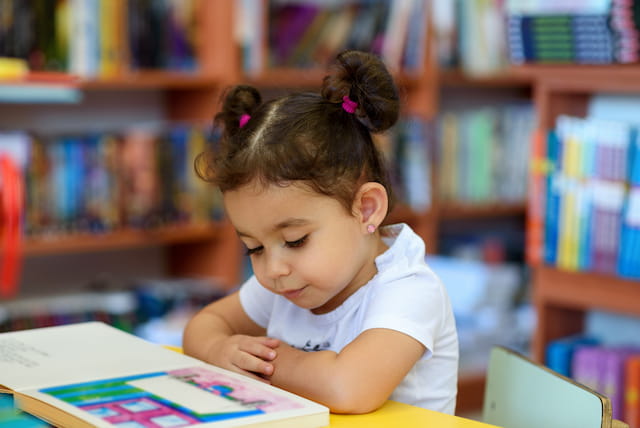 a young girl reading a book