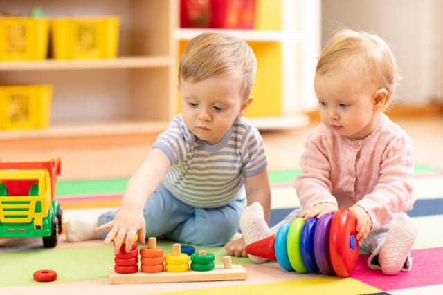 two babies playing with toys