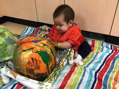 a baby playing with a toy