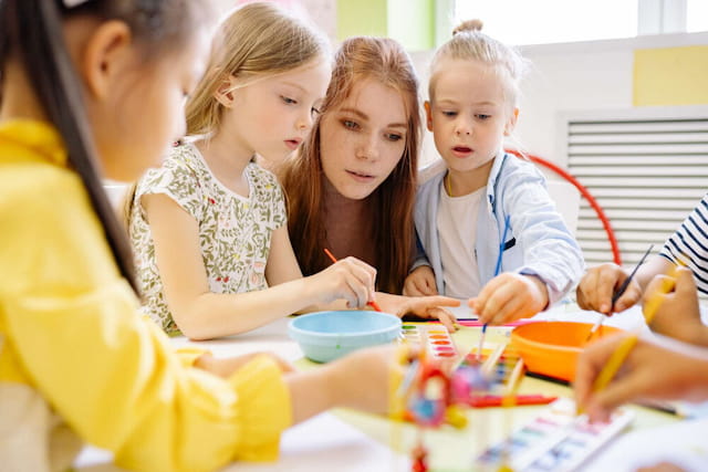 a group of children painting