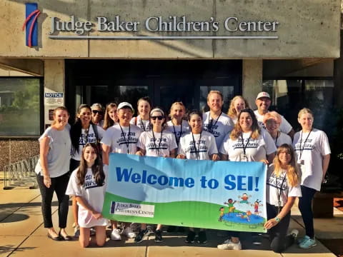 a group of people holding a banner
