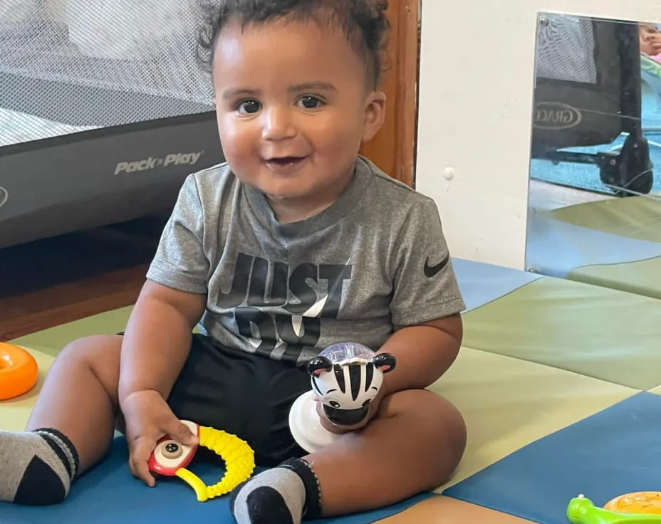 a baby sitting on the floor