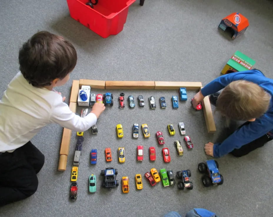 a couple of people playing with toys