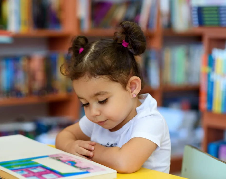 a young girl reading a book