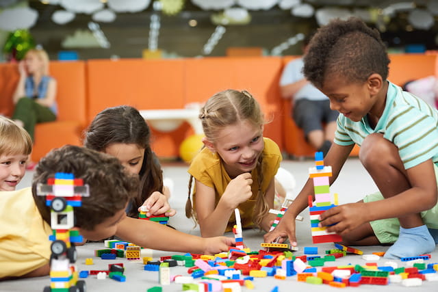 a group of children playing with toys