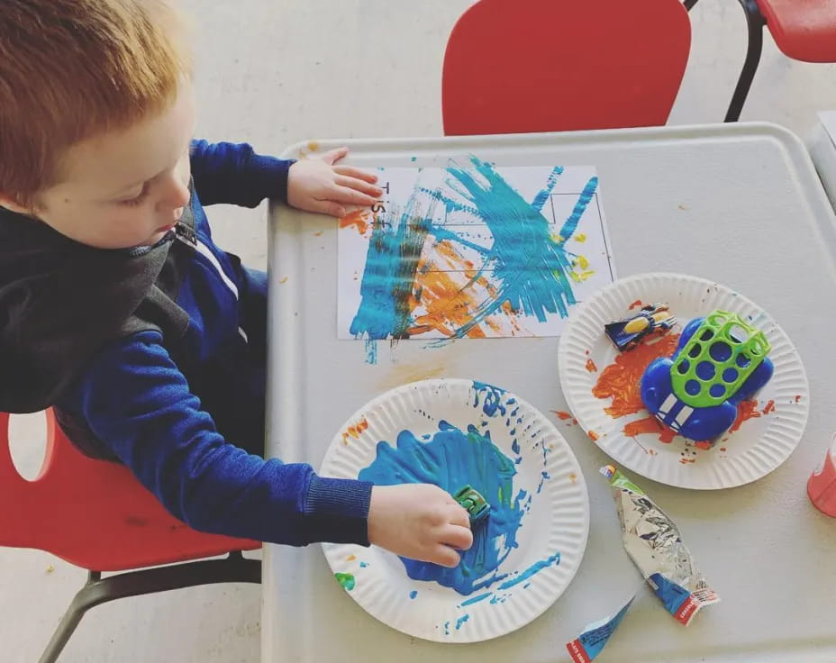 a child painting on a table