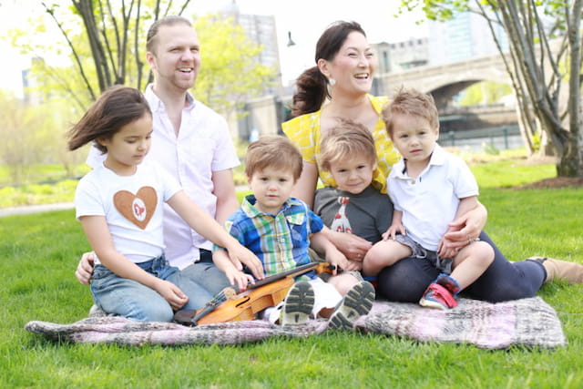 a family sitting on the grass