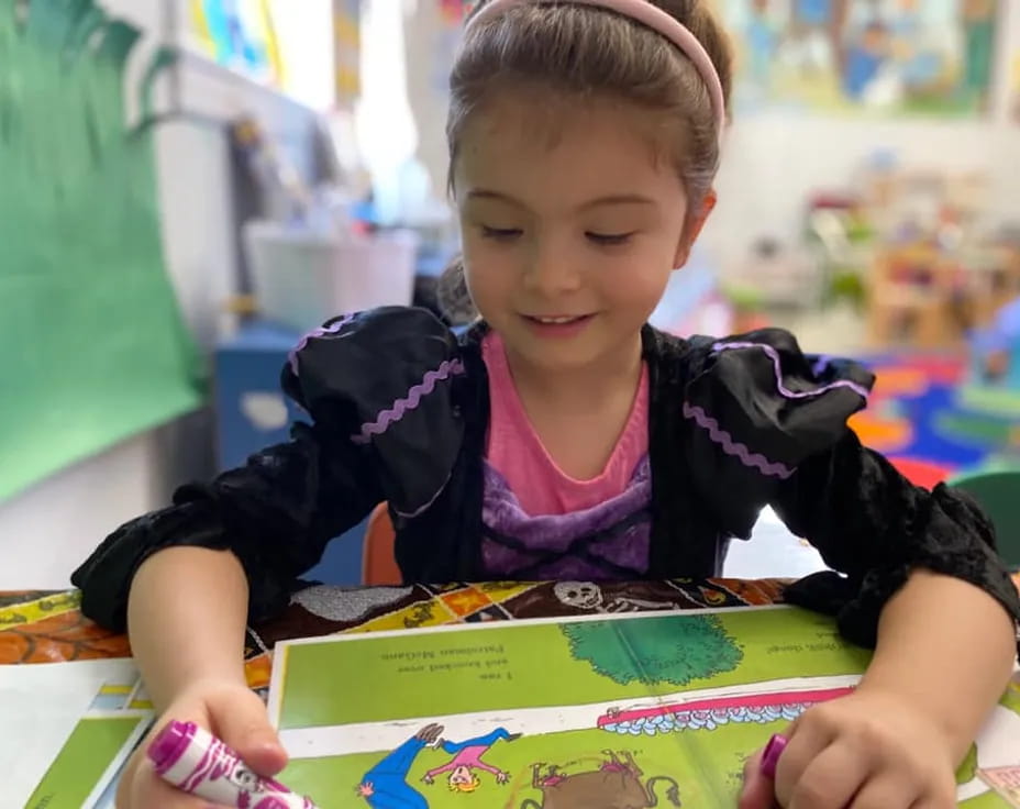 a young girl reading a book