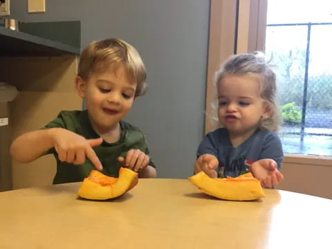 two children sitting at a table
