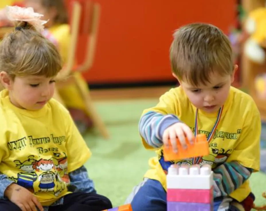 a couple of young boys sitting on the floor