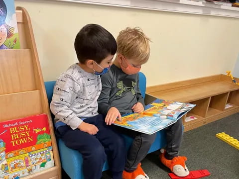 a few boys sitting on a bench