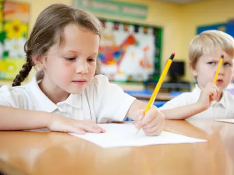 a few children sitting at a table