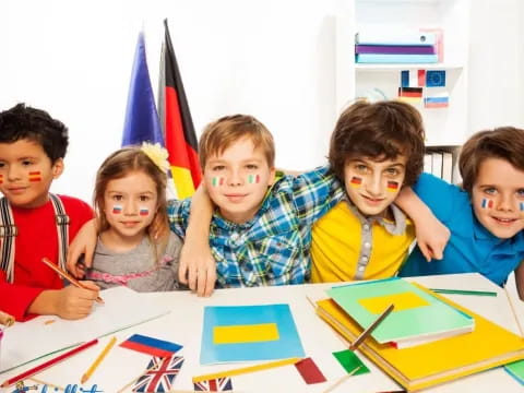 a group of children sitting at a table with flags