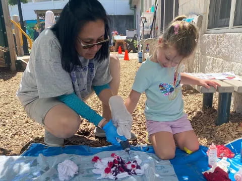 a woman and a child painting