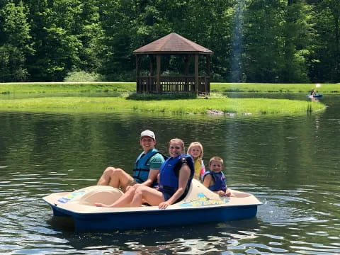 a group of people on a small boat in a lake
